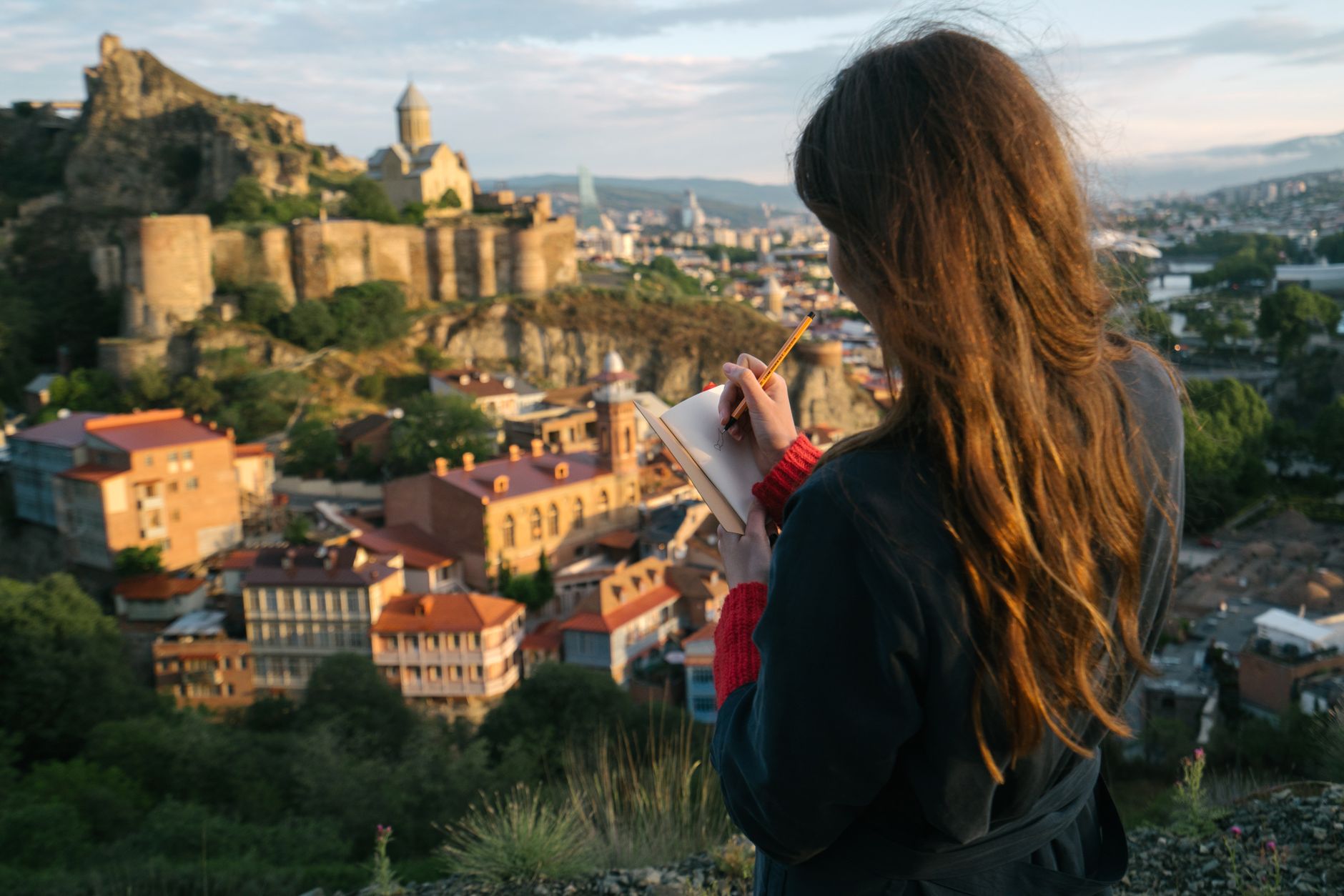 Travel Editor taking notes on a cliff